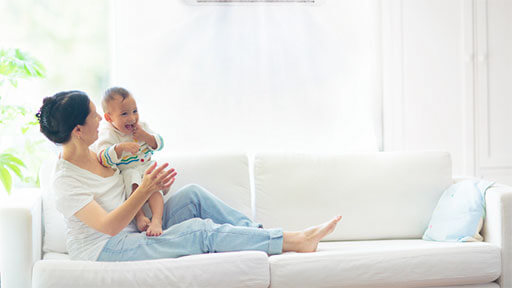 Woman and baby enjoying comfortable climate in home