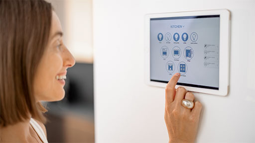 Woman adjusting programmable thermostat
